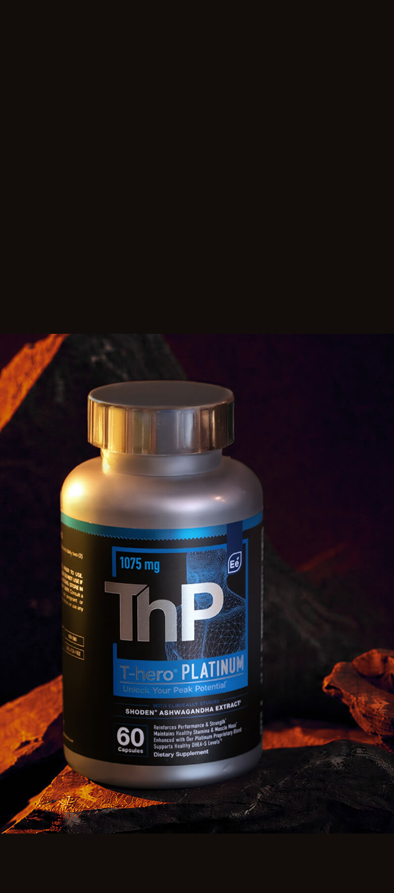 A bottle of T-hero Platinum dietary supplement on granite, set against a dark background with warm, dramatic lighting.